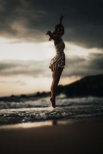 united states selective focus photography of woman jumps into water dance